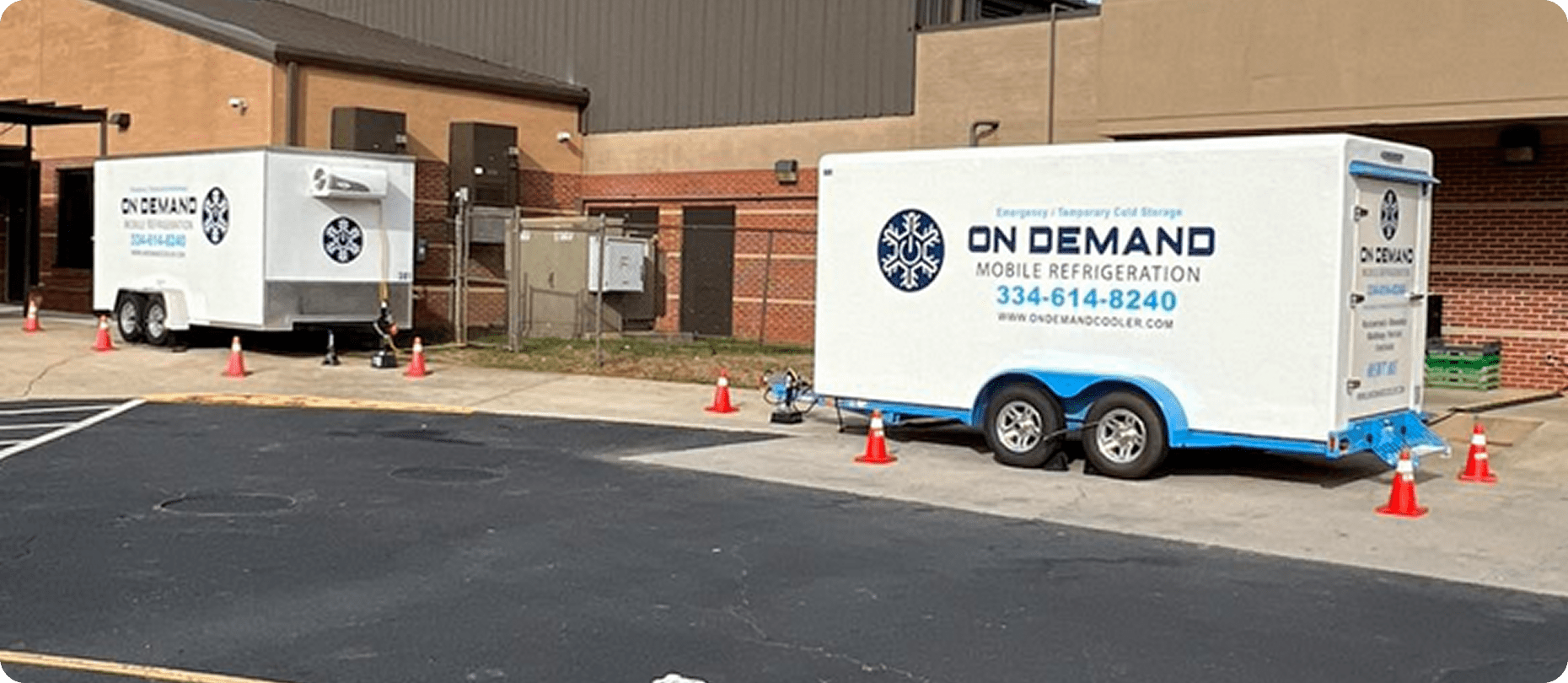 Mobile refrigeration units parked outside building